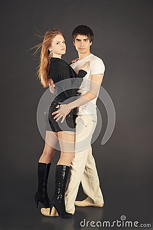 Fashion young couple, studio shot on black