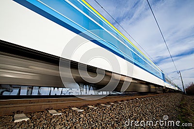 Fast train passing under a bridge on a lovely summer day