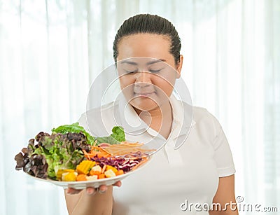 Fat woman eating salad