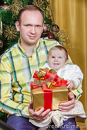 Father and child near Christmas fir-tree