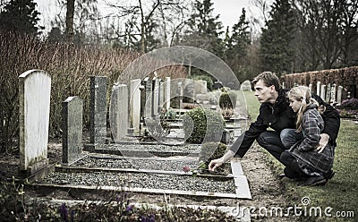 Father and daughter at grave