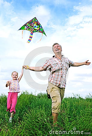 Father with daughter playing with kite