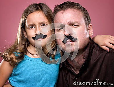 Father and Daughter Wearing Fake Mustaches