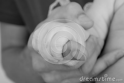 Father giving hand to a child, black and white