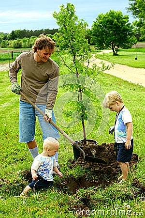 Father and his Children Planting Tree