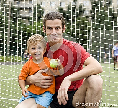 Father with his son after a football game, photo in motion