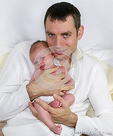 Father holding little four weeks old baby.