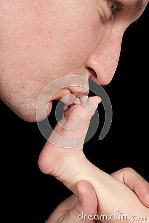 Father kissing baby feet