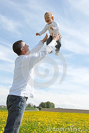 Father lifting his son up in the sky