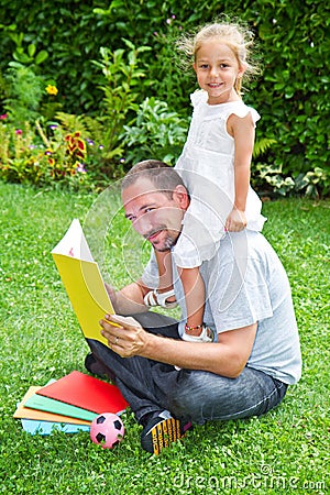 Father reading a book to his daughter