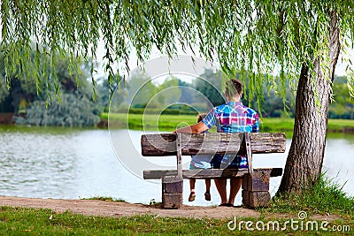 Father and son on the bench near the lake