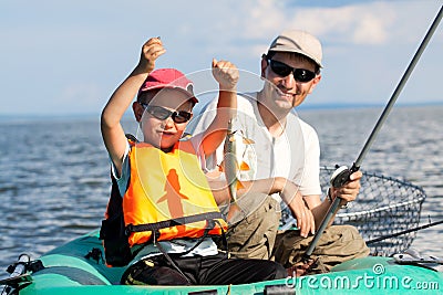 Father and son fish in a boat