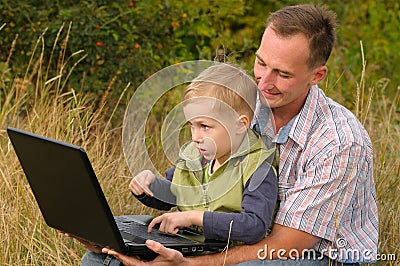 Father and son with laptop