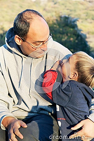 Father and son on natural background