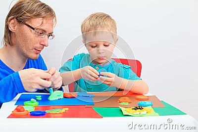 Father and son playing with plasticine