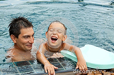 Father And Son Playing In A Swimming Pool Stock Photos Image 21214423