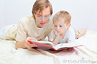 Father and son reading together