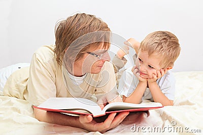 Father and son reading together