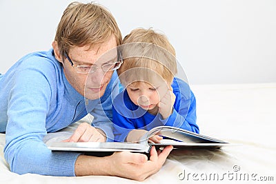 Father and son reading together