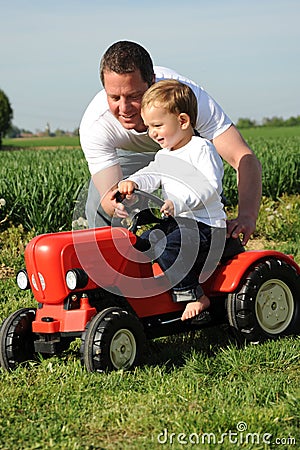 Father and son with red tractor