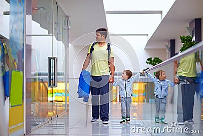 Father and son shopping together in mall