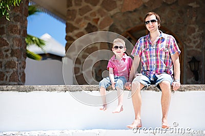 Father and son sitting together outdoors