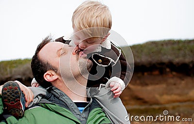 Father and son share a kiss