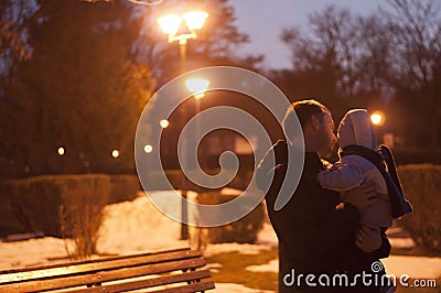 Father and son watching the street lamps at night, winter landscape