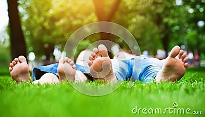 Feet on grass. Family picnic in spring park