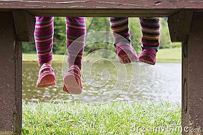 Feet hanging from a bench