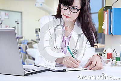 Femal physican write medical report