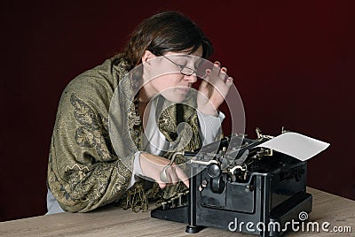 Female author typing on an old typewriter