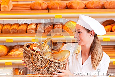 Female baker selling bread in her bakery
