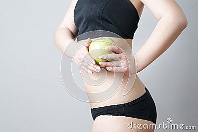 Female body with green apple