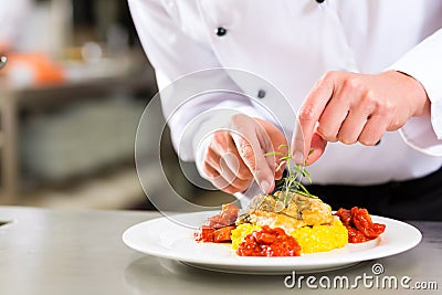 Female Chef in restaurant kitchen cooking