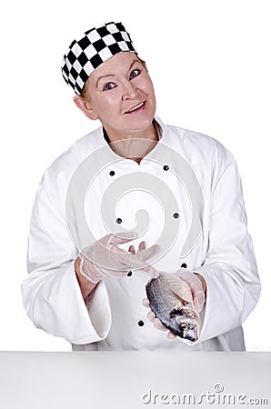 Female chef shows on a fresh sea bream