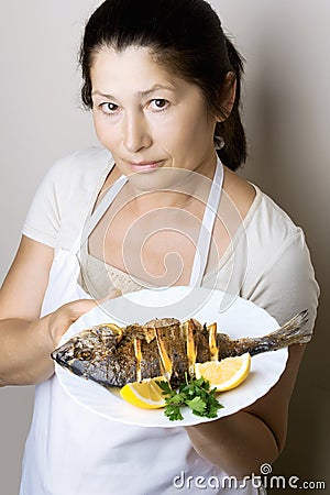 Female chef shows sea bream fish
