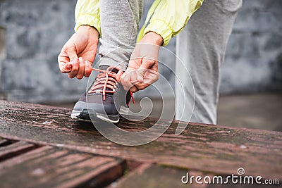 Female city runner lacing sport footwear