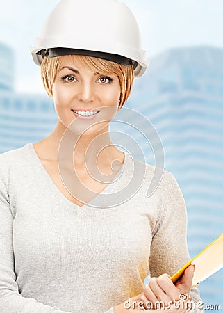 Female contractor in helmet with bluepring