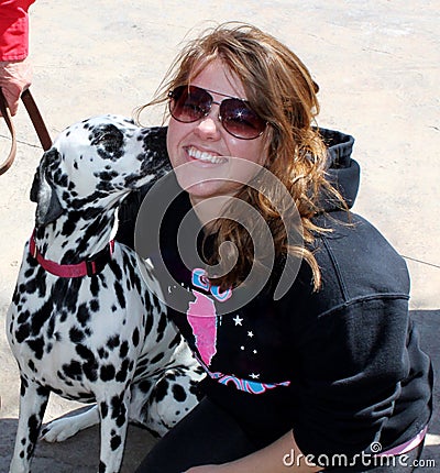 Female Dalmation Dog Kissing Smiling Teen Girl