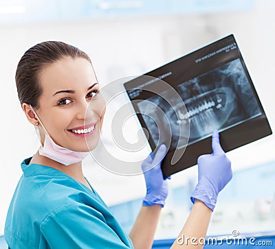 Female dentist with x-ray picture