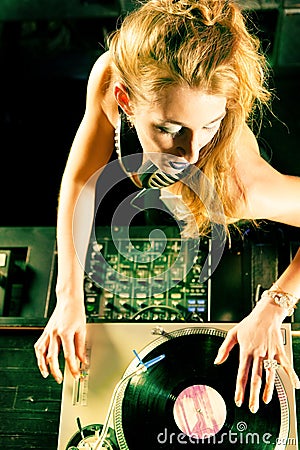 Female DJ at the turntable in Club