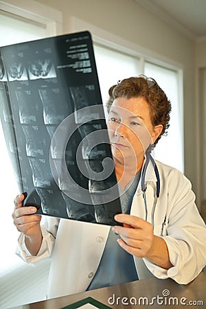 Female Doctor Reading MRI Film Scans