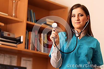 Female doctor smiling with stethoscope in hands