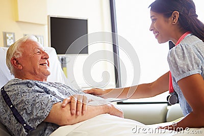 Female Doctor Talking To Senior Man In Hospital Room