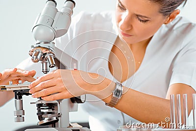 Female doctor working with a microscope