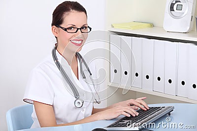 Female doctor working on pc computer