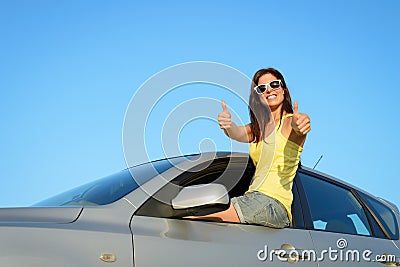 Female driver in car approving