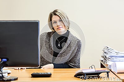 Female engineer at working place with drawings on table
