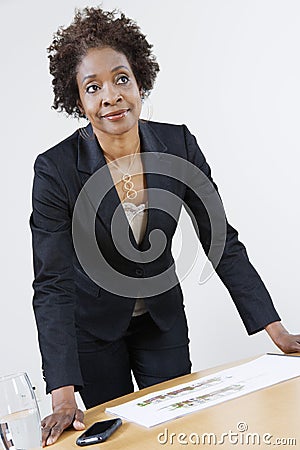 Female Estate Agent Leaning On Table